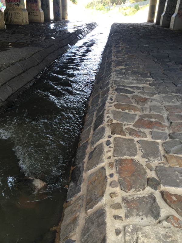 Stone canal under bridge