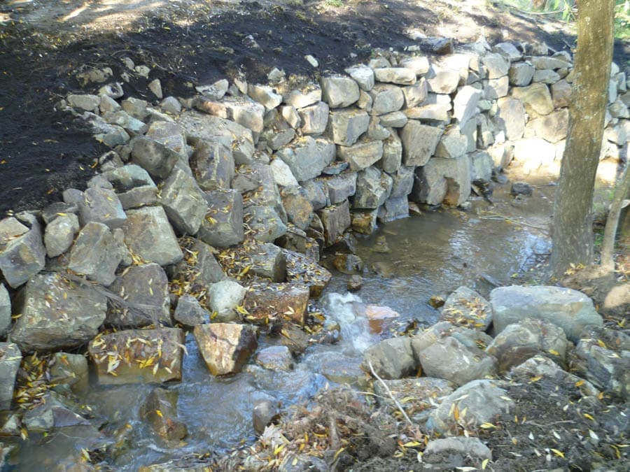 Stone retaining wall with water