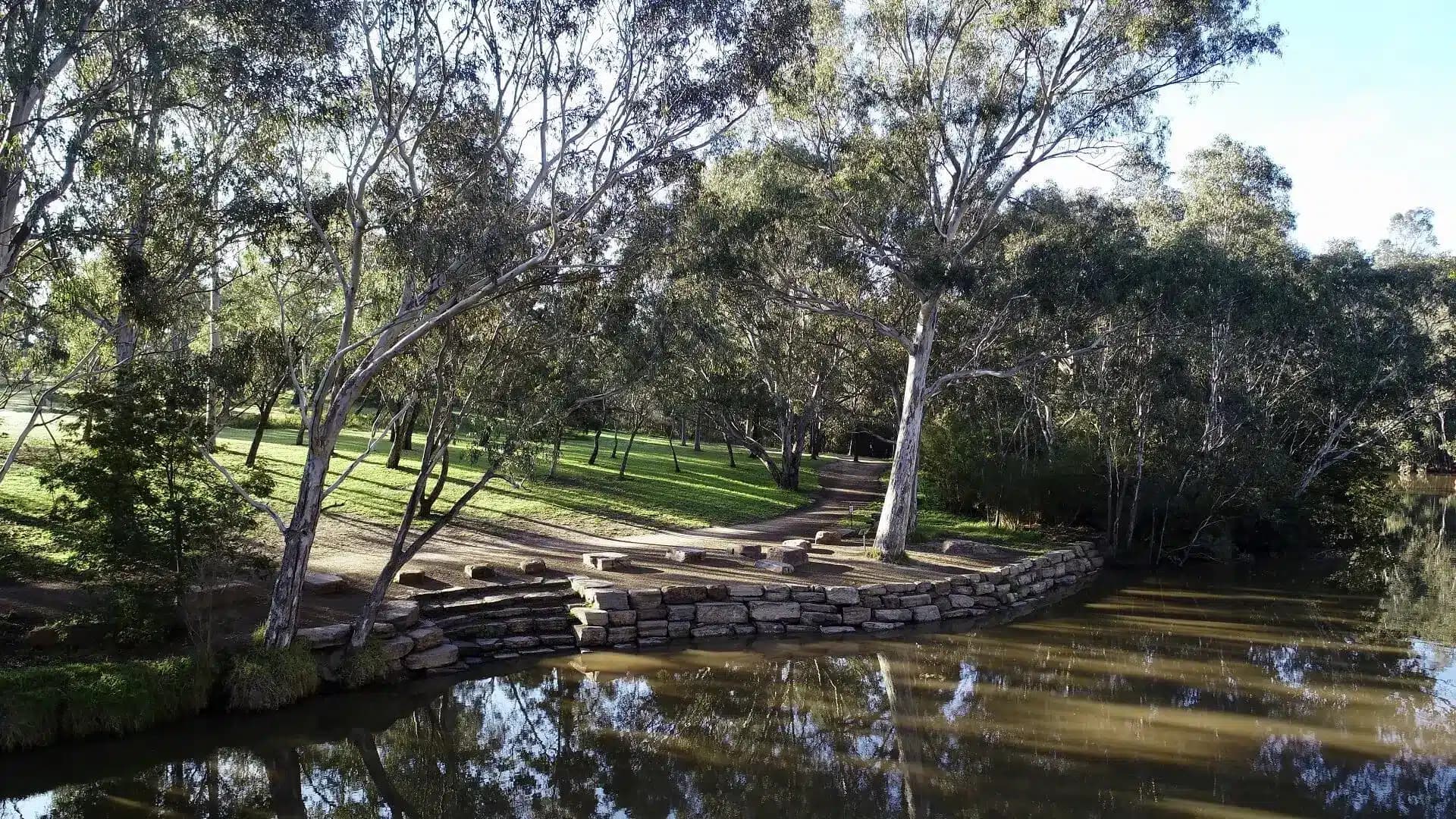 Tree-lined creek with stone steps along the bank
