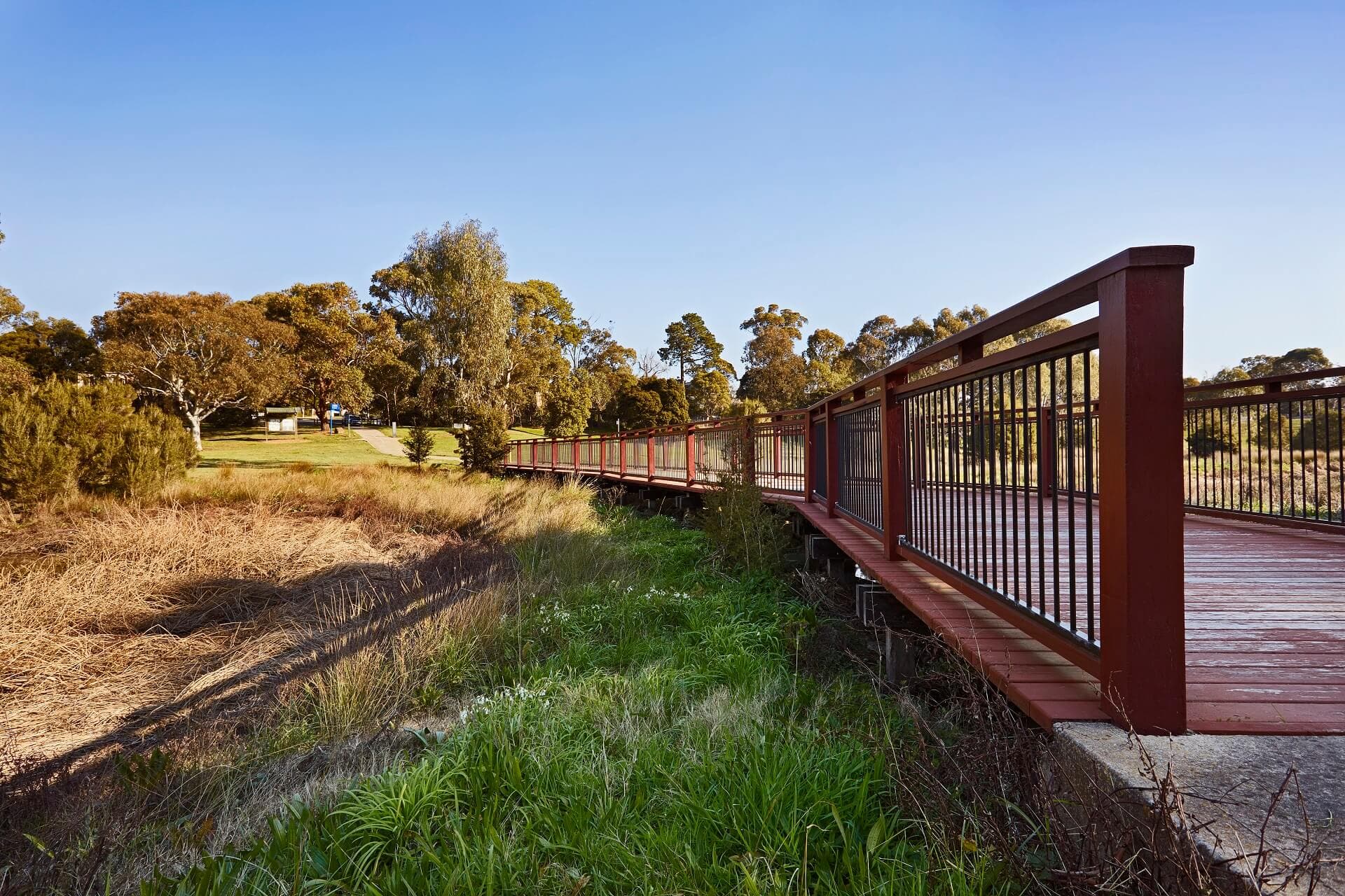 Wooden bridge through park