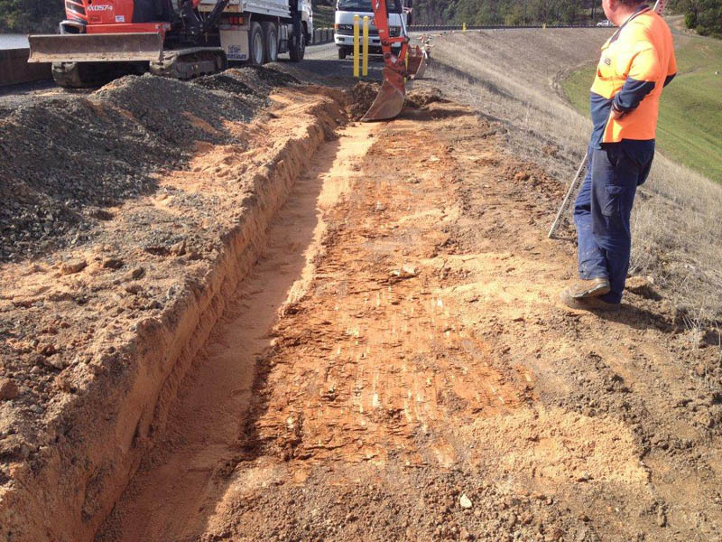 Construction site trench and worker