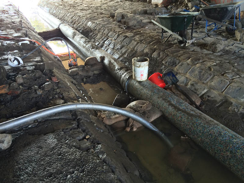 Construction pipes in muddy trench