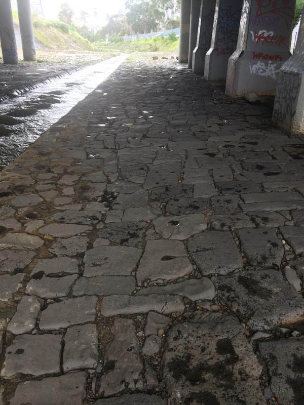 Under bridge cobbled path