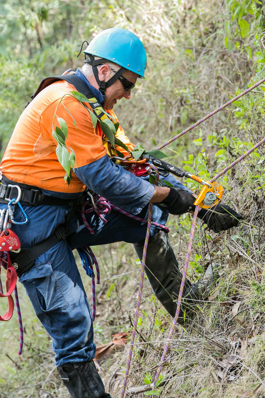 Worker on ropes outdoors