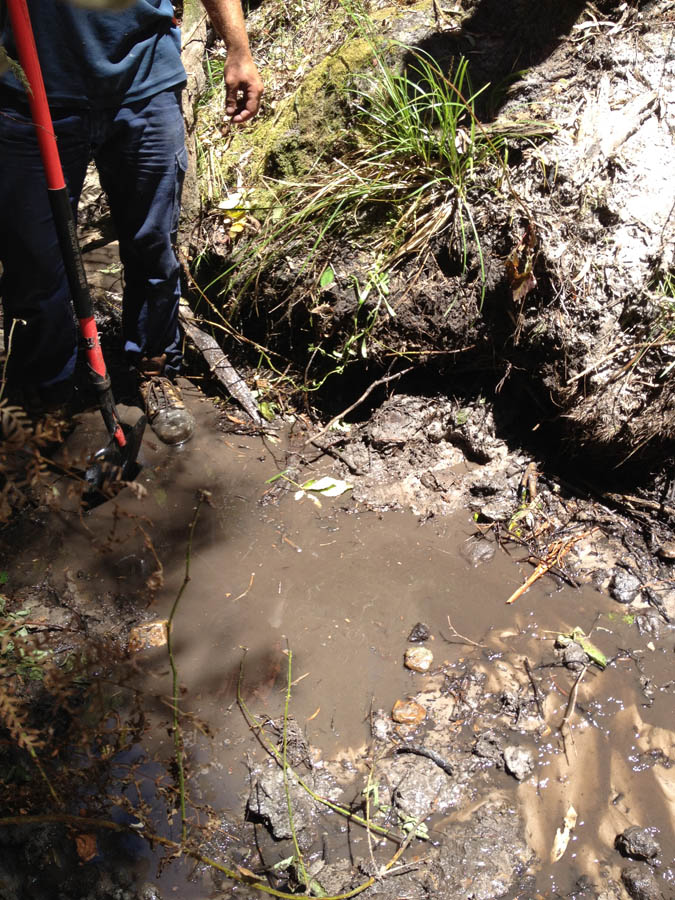 Digging muddy ditch outdoors