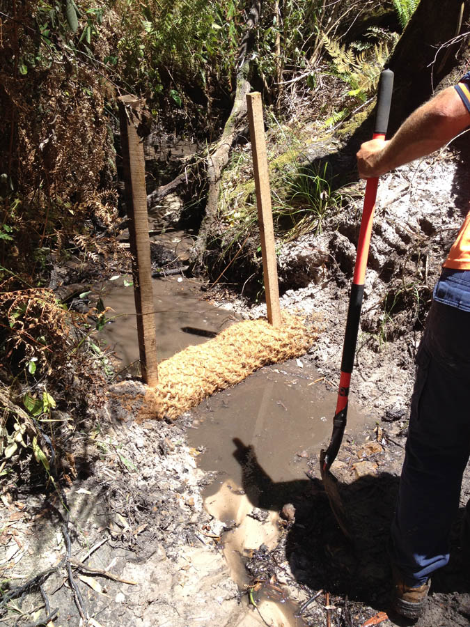 Clearing mud with shovel