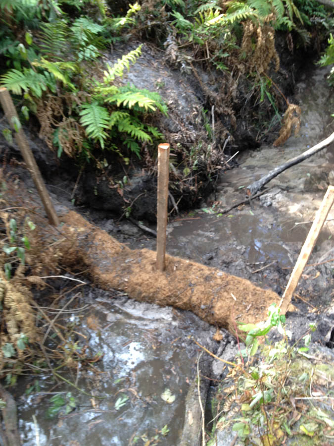 Erosion control log with stakes