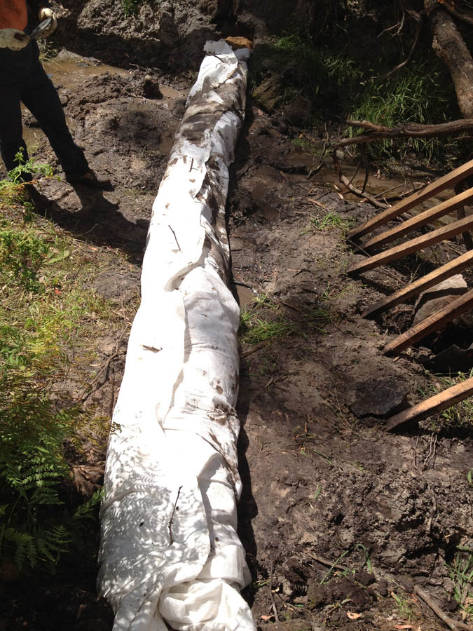 Drainage pipe installation in soil