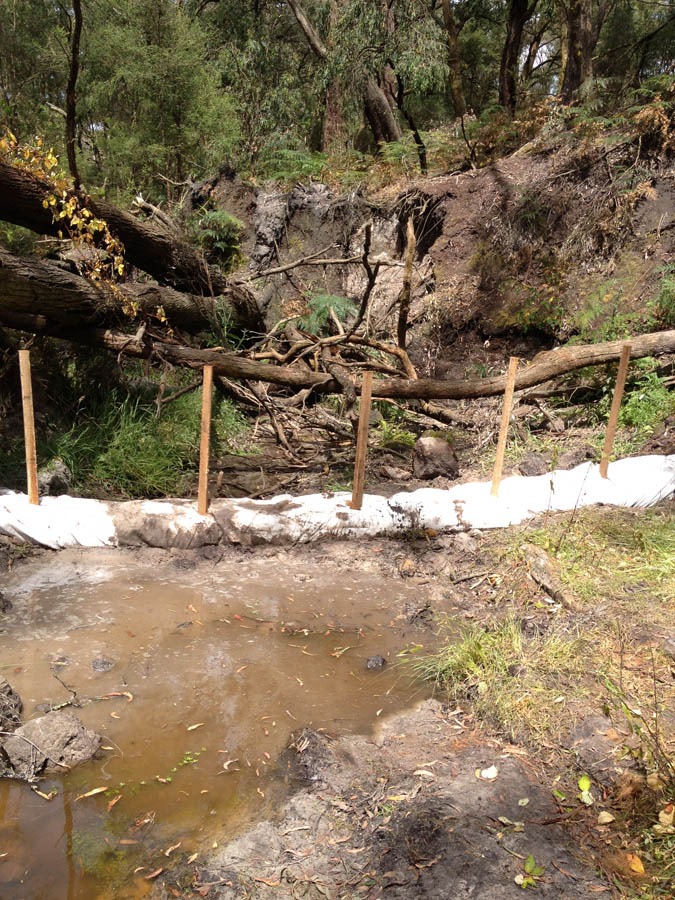 Wooden barrier with erosion control