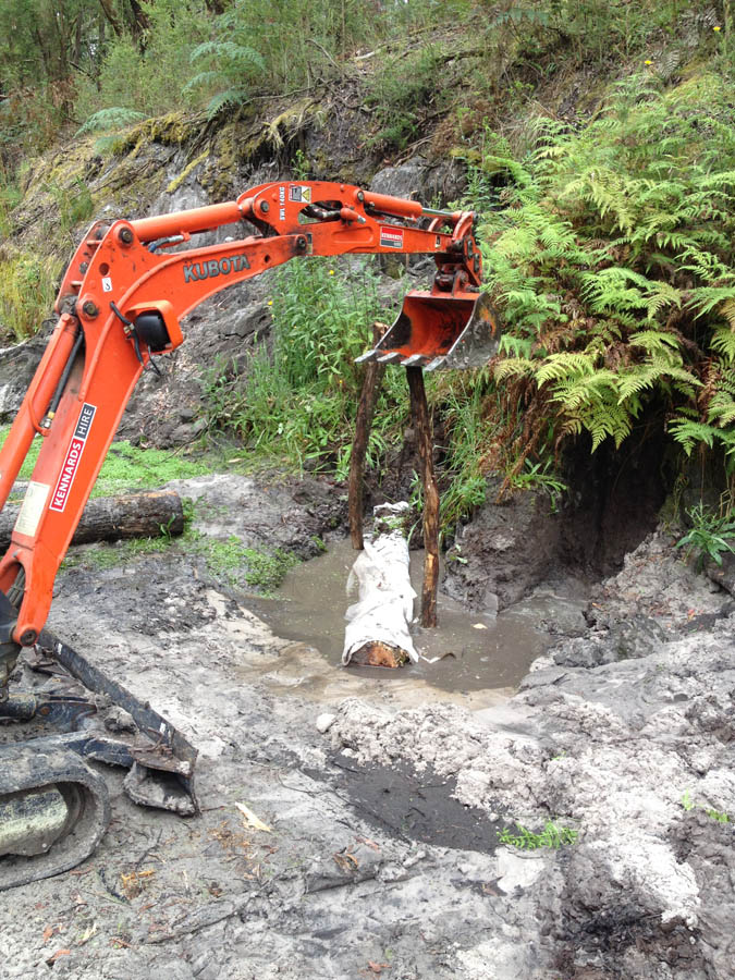 Excavator removing debris from water