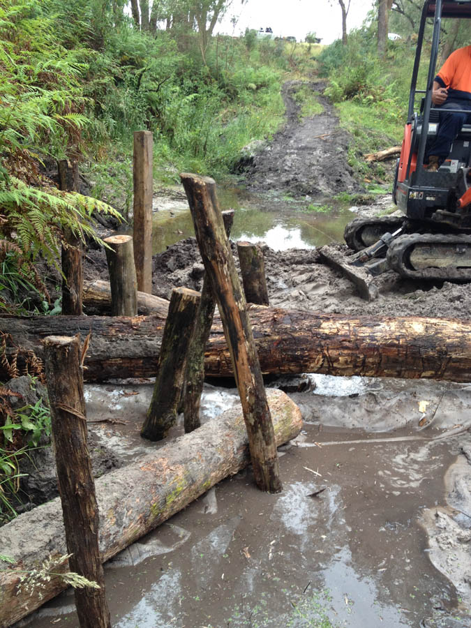 Construction of wooden bridge over stream