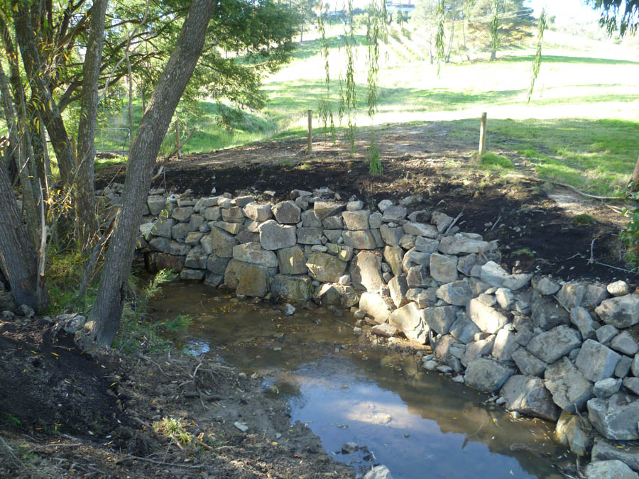 Stone retaining wall with creek