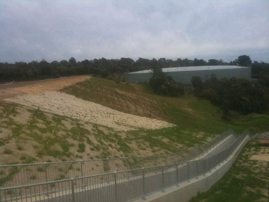 Grassy hill with a large building