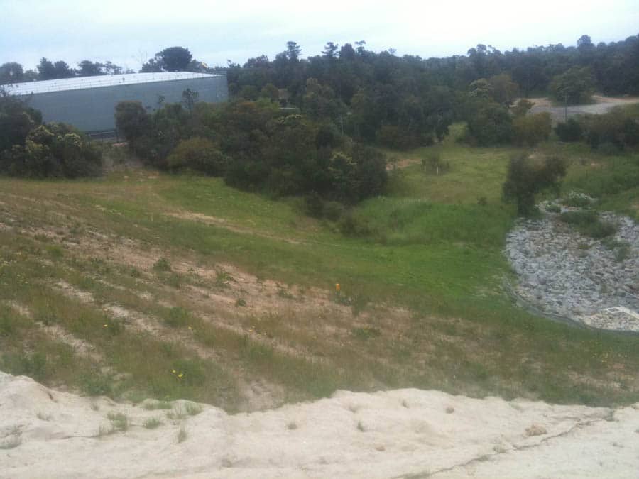 Grassy hill with building background