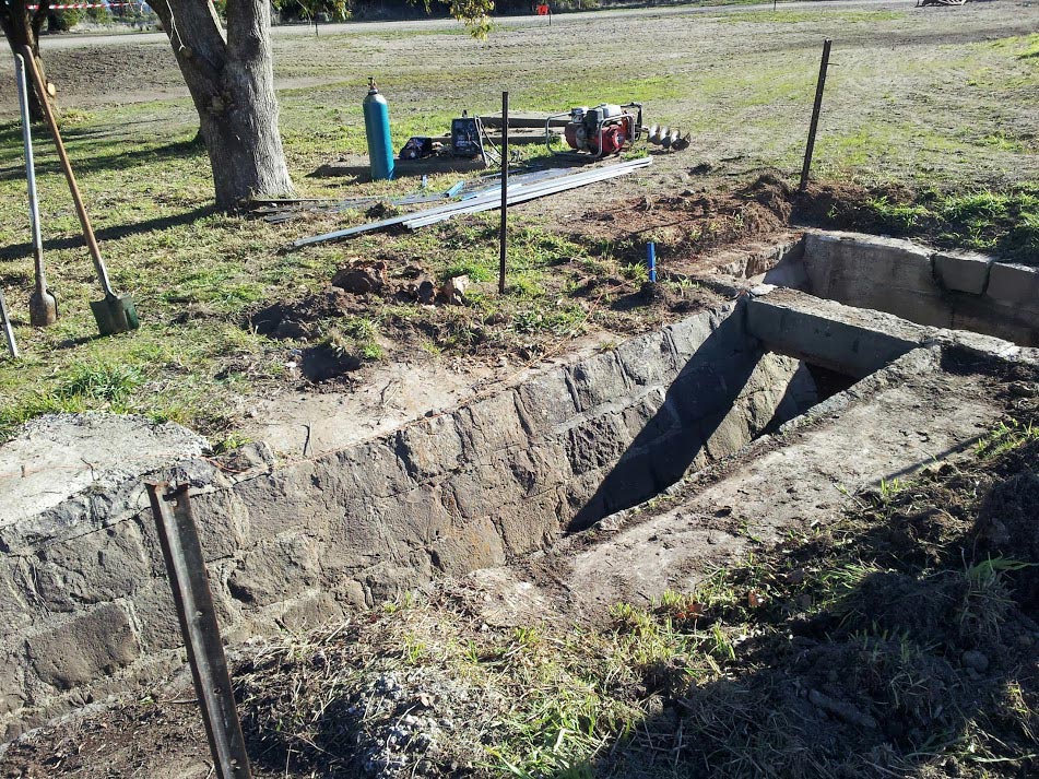 Yard excavation with stone wall