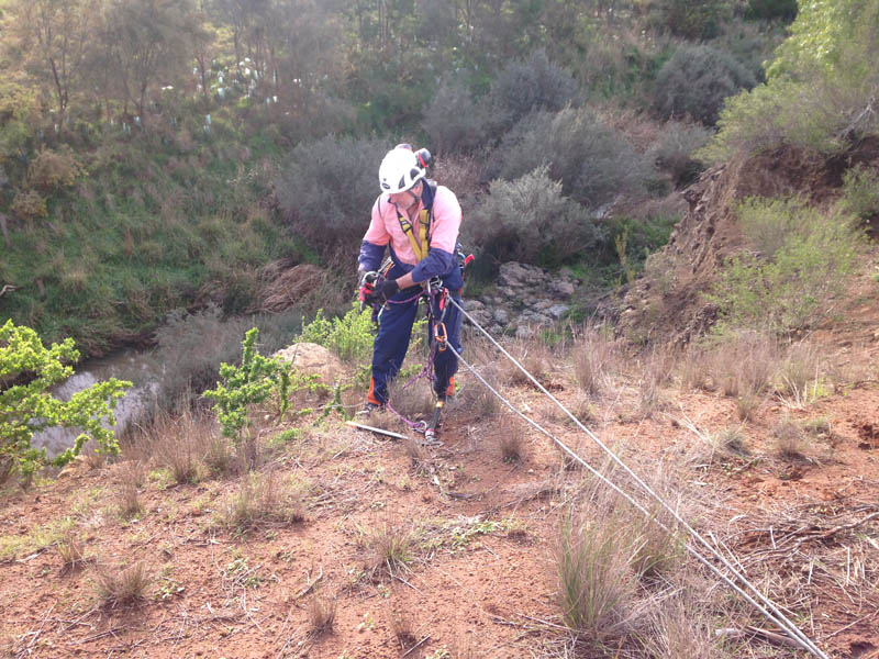 Rappelling down a hillside