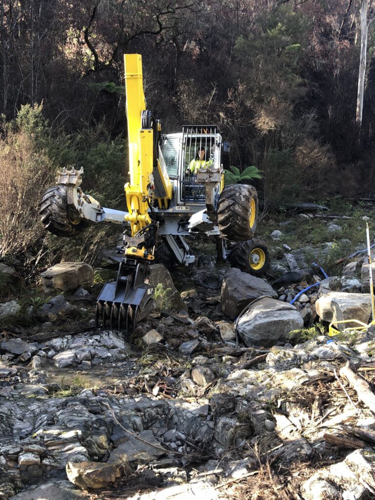 Excavator working on rocky terrain