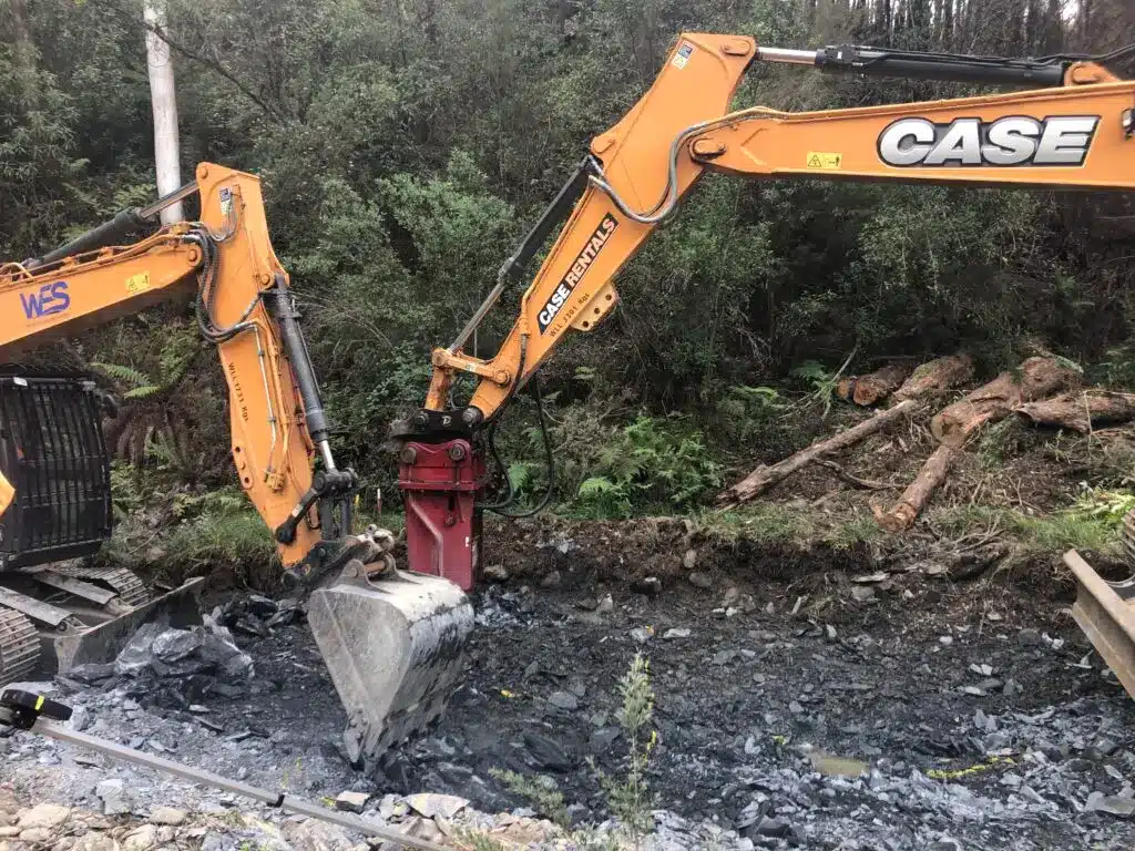 Excavator clearing debris