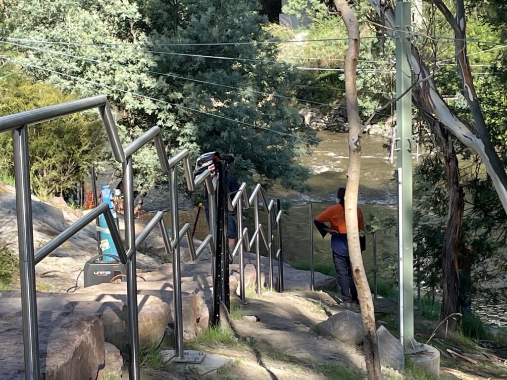 Man by river railing