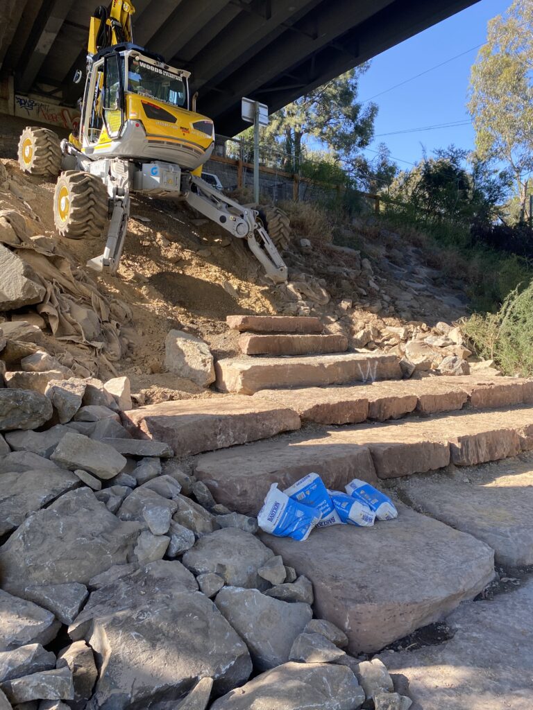 Construction machine building stone steps