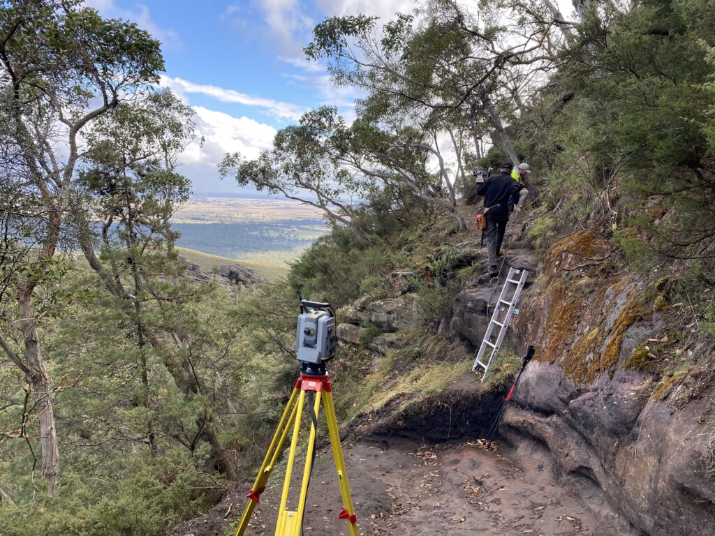 Surveyor with equipment on hillside